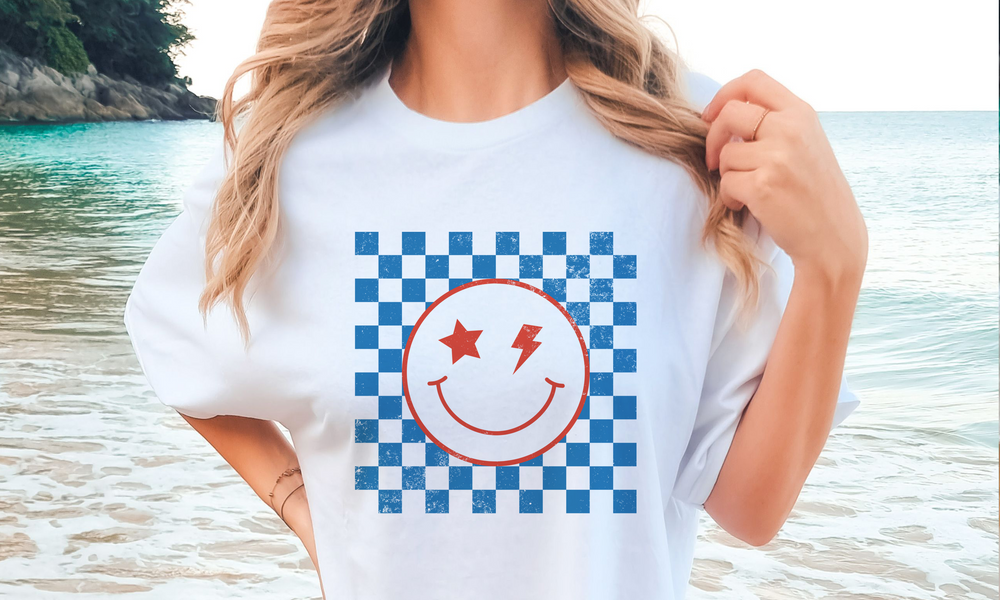 This Checkered Distressed Smiley Unisex Tee ain't your ordinary t-shirt! Shake up your wardrobe with this super cool, retro-checkered design featuring a hip hop style smiley face. Whether you're layering away or keeping it casual, this comfy tee is the perfect way to make a statement without saying a word!