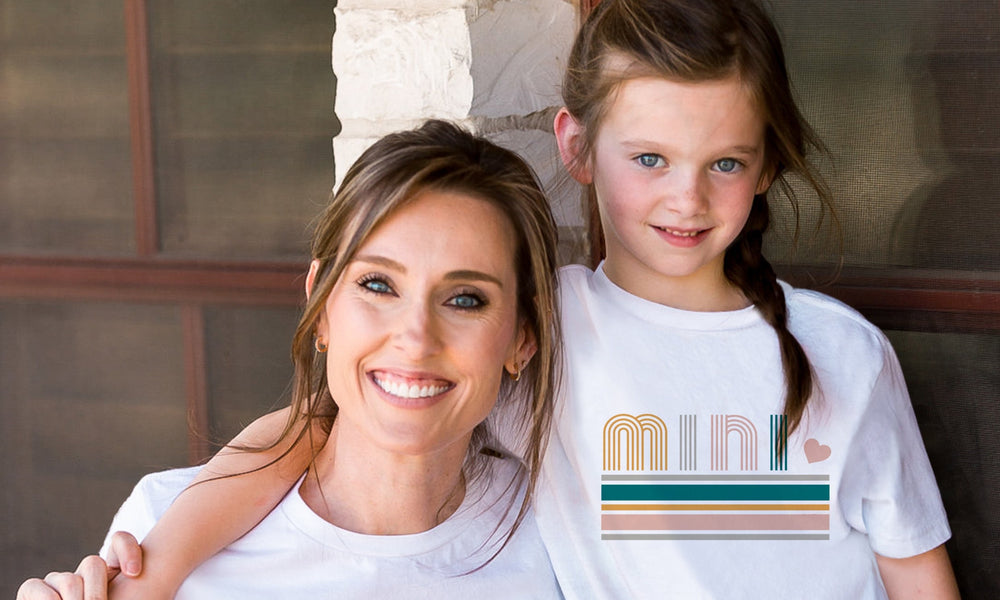 Introducing our delightful Momma and Me T-Shirt Set, a perfect way to showcase the bond between a mother and her child! Crafted with love and care, this adorable matching set is designed to celebrate the special connection shared by moms and their little ones.