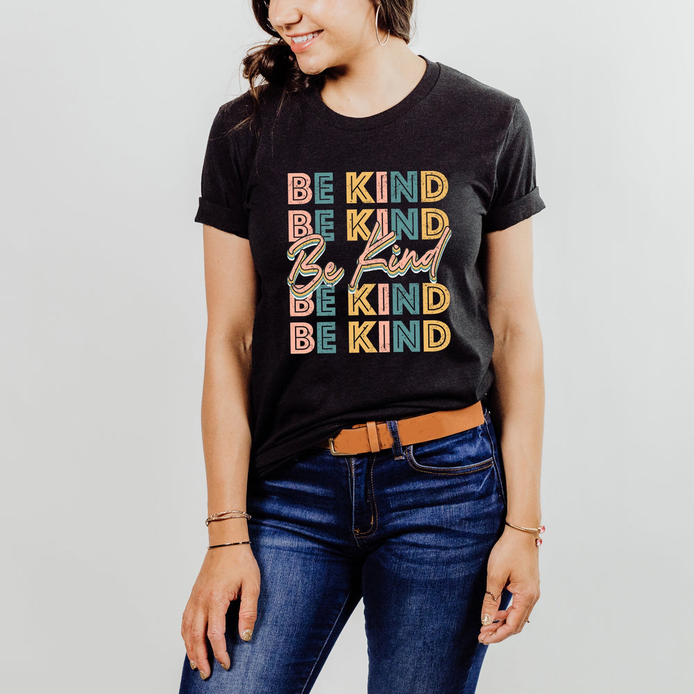 Ideal for sunny days, this t-shirt is a must-have with its distressed retro style "Be Kind" lettering in white or heather black. Made from lightweight and soft material, it provides exceptional comfort. You can effortlessly layer this look with a lightweight cardigan for cooler evenings or simply wear it with shorts and sandals for a comfortable and casual look on a warm afternoon.